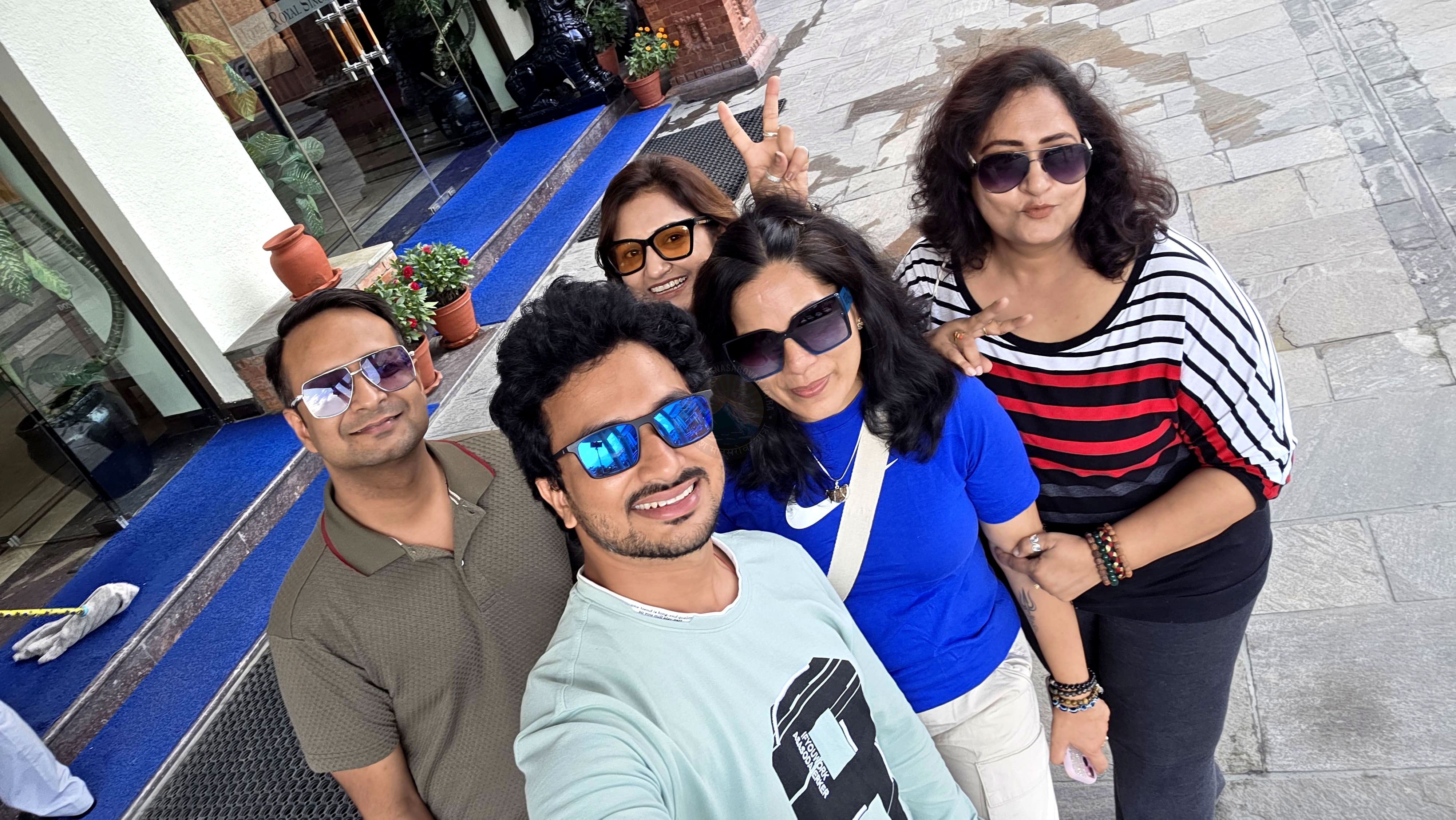 Group of smiling pilgrims on Kailash Yatra, showcasing friendship, happiness, and the joyous spirit of the journey