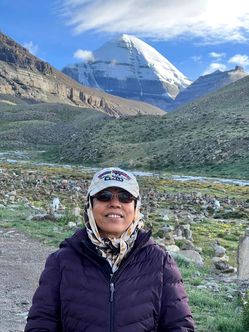 Pilgrims standing joyfully in front of Mount Kailash during Kailash Mansarovar Yatra, reflecting peace and divine connection