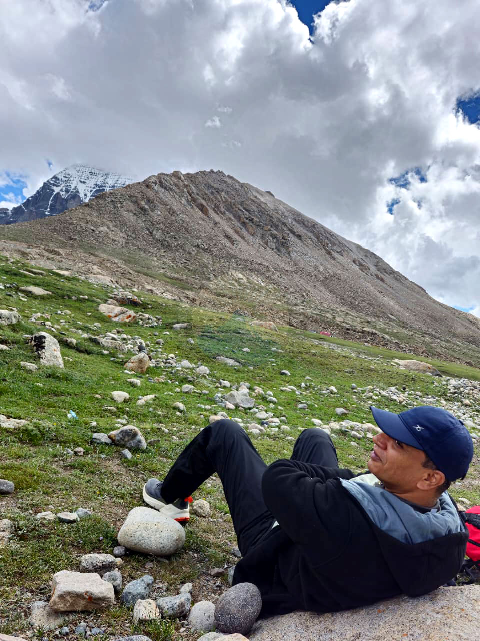 Pilgrims experiencing peaceful reflection surrounded by the Himalayas during Kailash Mansarovar Yatra