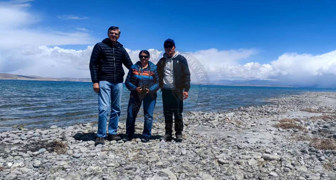 Pilgrims experiencing tranquility at the sacred lakeshores of Lake Manasarovar