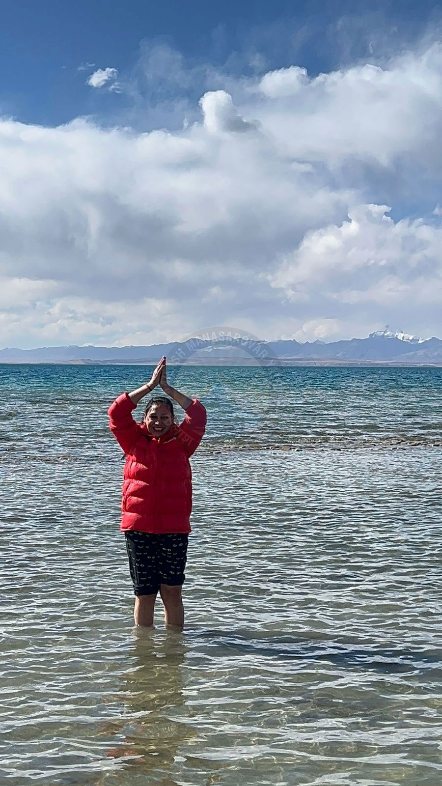 Pilgrims smiling and enjoying spiritual peace at Lake Manasarovar during the Kailash Yatra