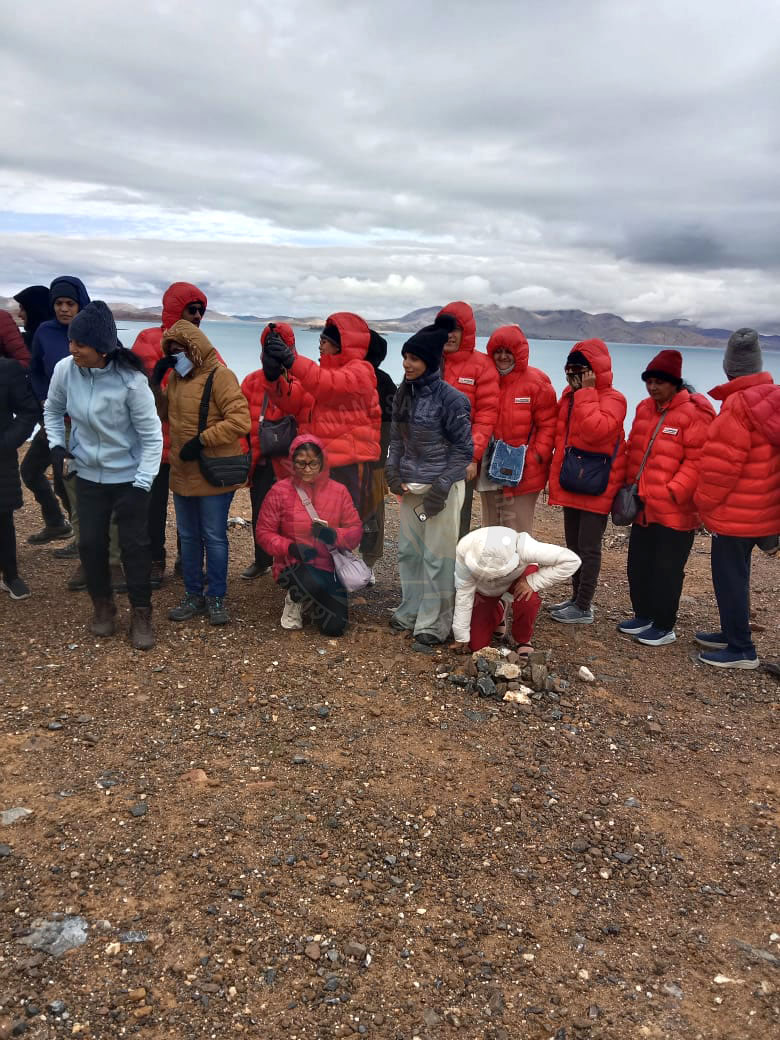 Pilgrims bonding at the scenic holy lake surrounded by mountains