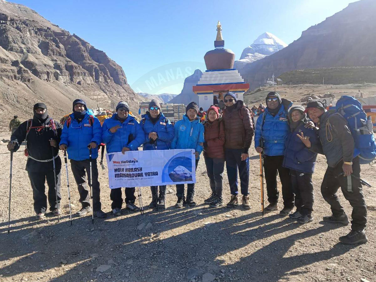 Pilgrims group on Kailash Mansarovar Yatra with Mount Kailash in background organized by Max Holidays