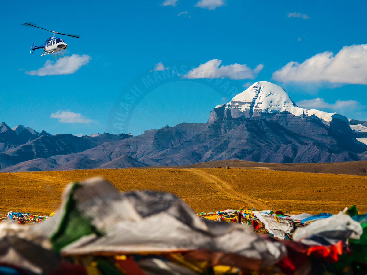 Helicopter flying near Mount Kailash during Kailash Mansarovar Yatra aerial darshan with prayer flags in Tibet