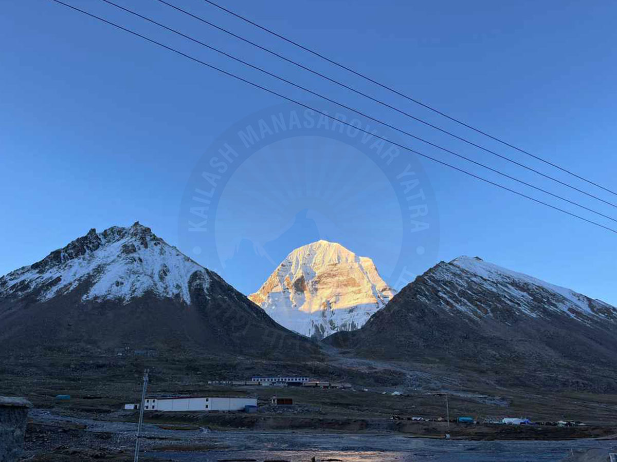 Sunrise view of Mount Kailash with snow-covered peaks and clear blue sky in the Himalayas