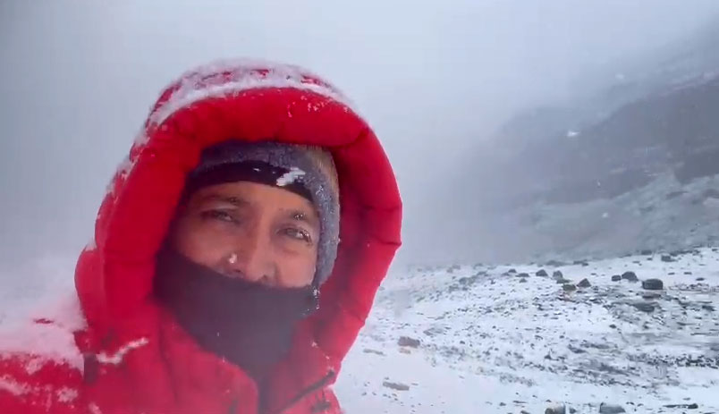 Person capturing video at Mount Kailash during heavy snowfall